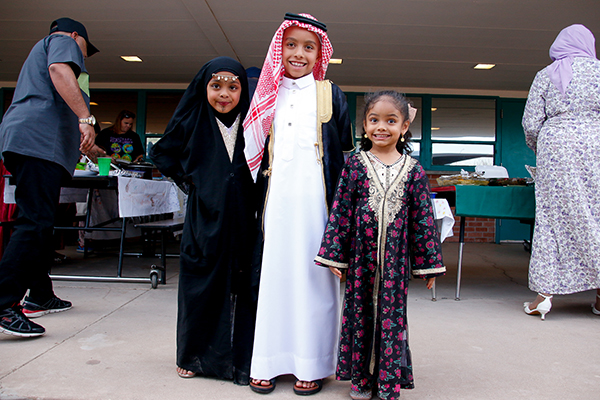 Three students show off their traditional Middle Eastern dress