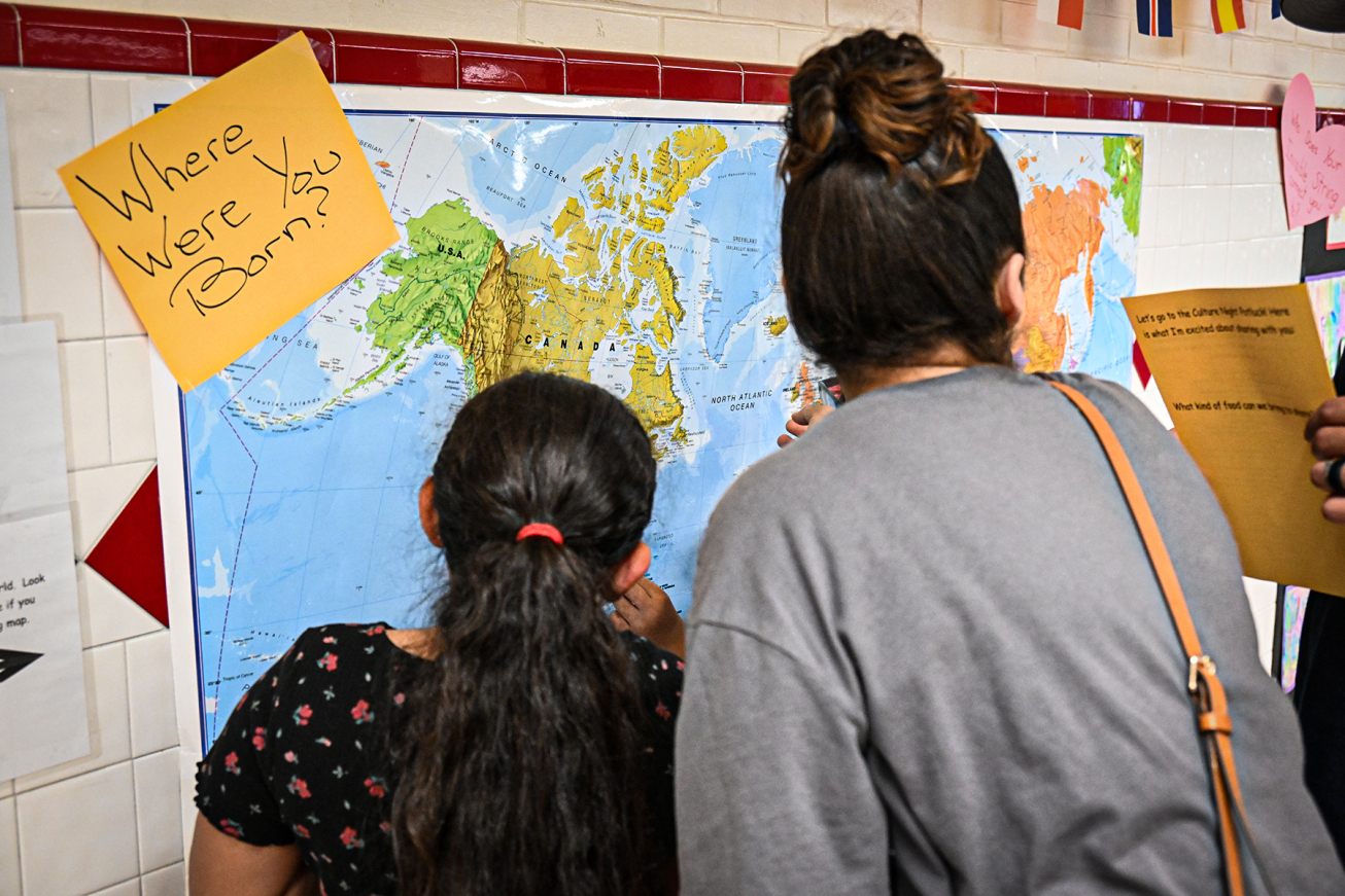 A student and her mom look at the map showing where students and their families were born